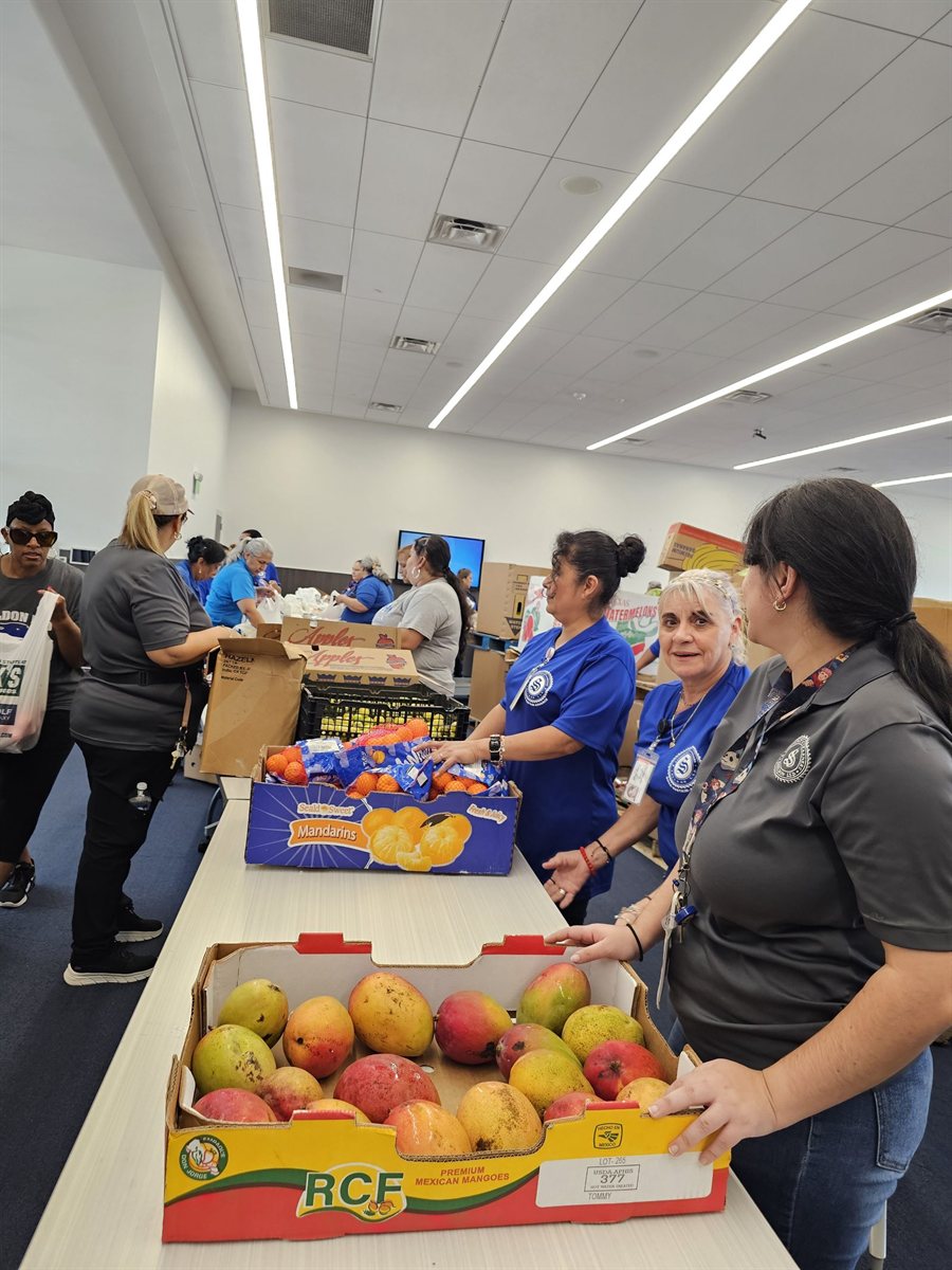 Nate&rsquo;s Way volunteers sorting fresh produce at a weekly food drive.